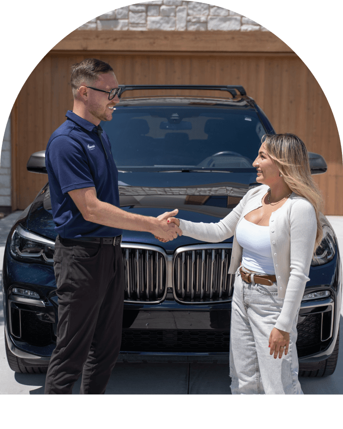 Maverick associate shaking hands with customer in front of vehicle